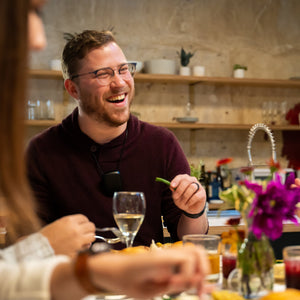 man sitting at table smiling wearing his pureAir personal